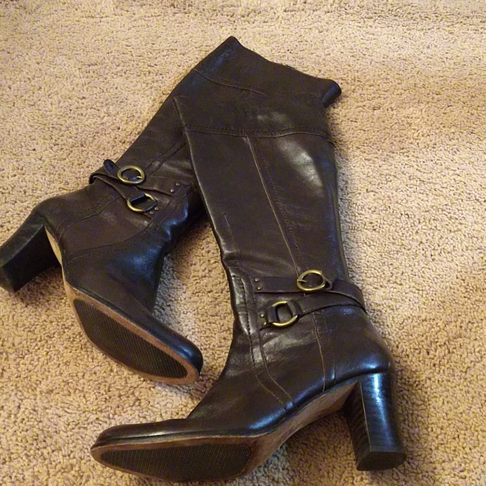 Tall heeled brown leather boots